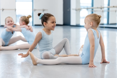 group of children in ballet clothes playing together