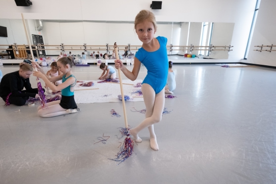 A student hanging out at camp, during craft time