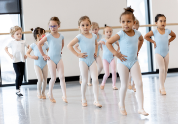 Children's Division students practice moving in straight lines in the studio.