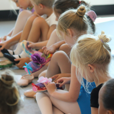 young dancers decorating pointe shoes