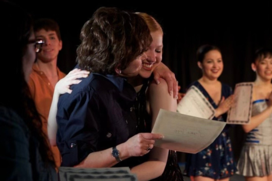 A dancer hugs her sponsor.
