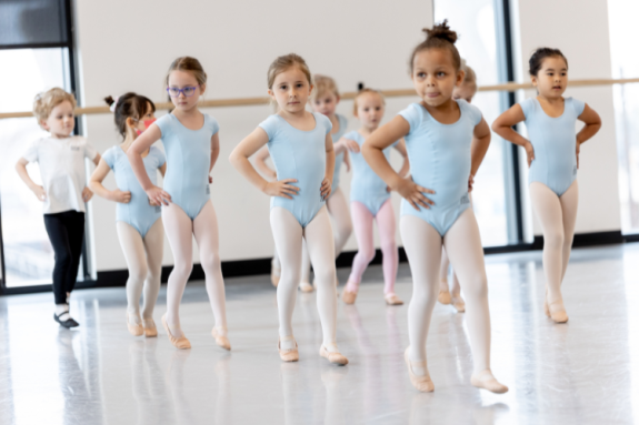 Children's Division students practice moving in straight lines in the studio.