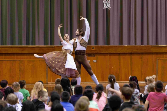 man and woman dancing in front of audience