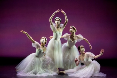 a group of women in white dresses dancing
