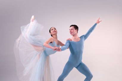 a person and person in blue leotards dancing
